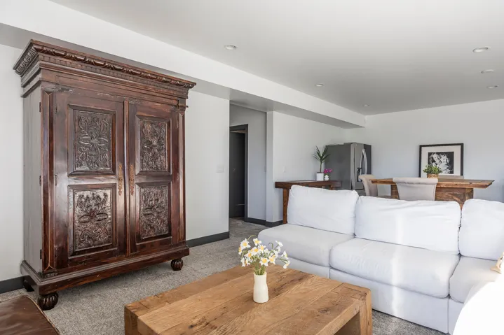 Living room featuring carpet and baseboards