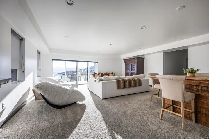 Carpeted living room featuring baseboards and recessed lighting
