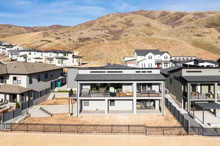 Back of property featuring a residential view, a fenced backyard, a patio area, and a mountain view