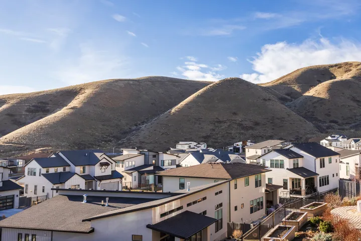 View of mountain background featuring nearby suburban area