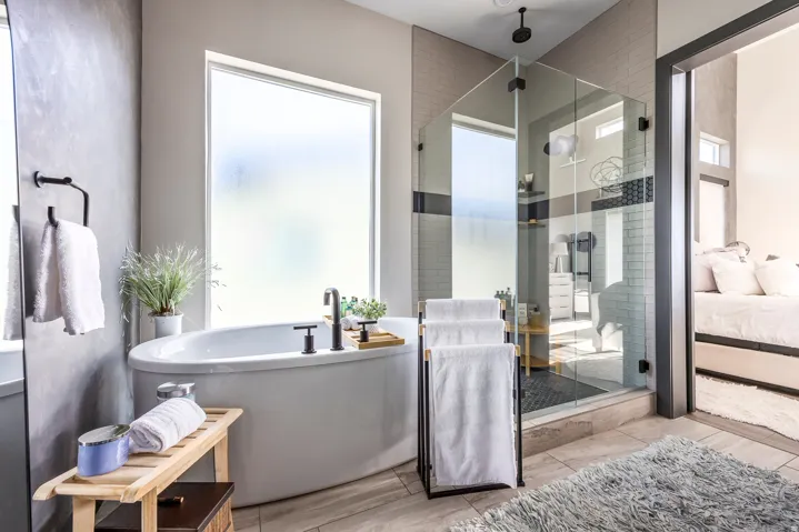 Bathroom with ensuite bathroom, a shower stall, and a freestanding tub