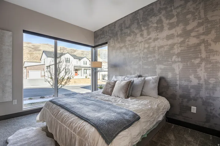Bedroom with wallpapered walls and carpet flooring