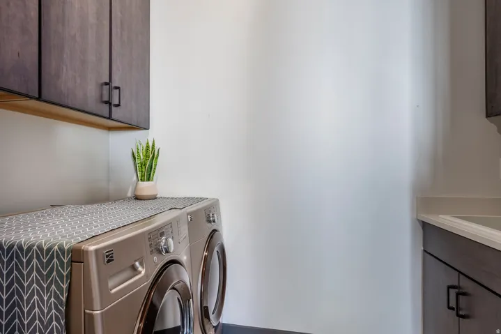Laundry area with cabinet space and washing machine and dryer