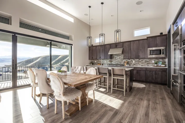 Dining room with a mountain view, a high ceiling, and dark wood finished floors