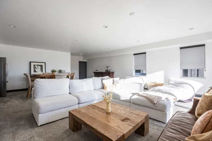 Living area with carpet flooring and recessed lighting