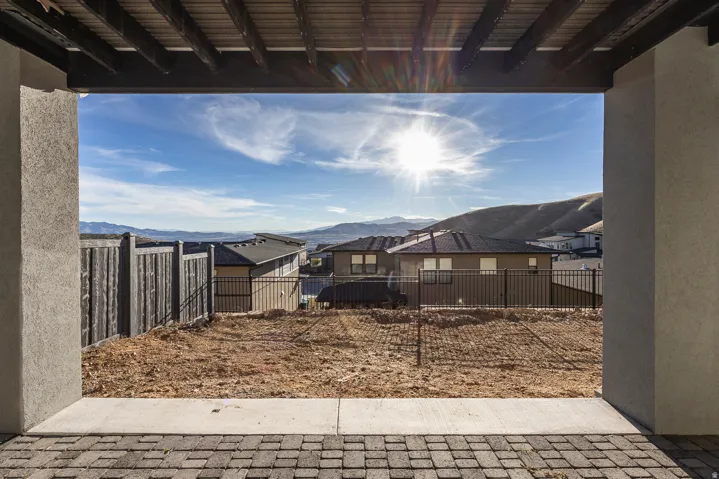Fenced backyard with a patio area and a mountain view