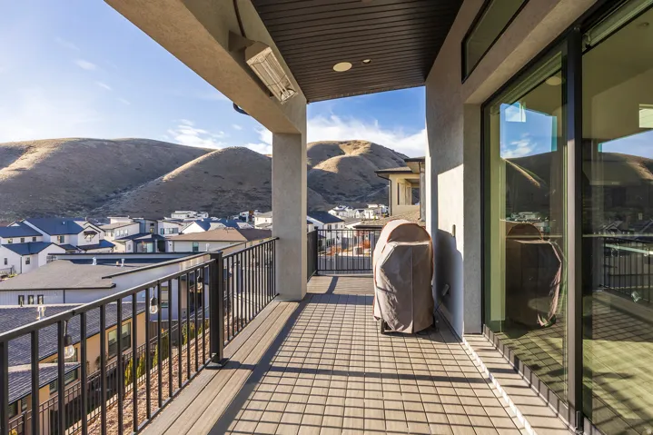 Balcony with a mountain view, a grill, and a residential view