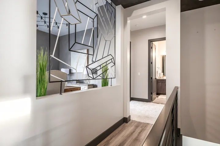 Corridor with light wood-type flooring and baseboards
