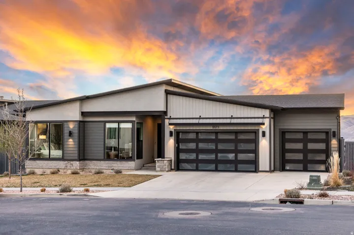 Contemporary home featuring a garage and concrete driveway
