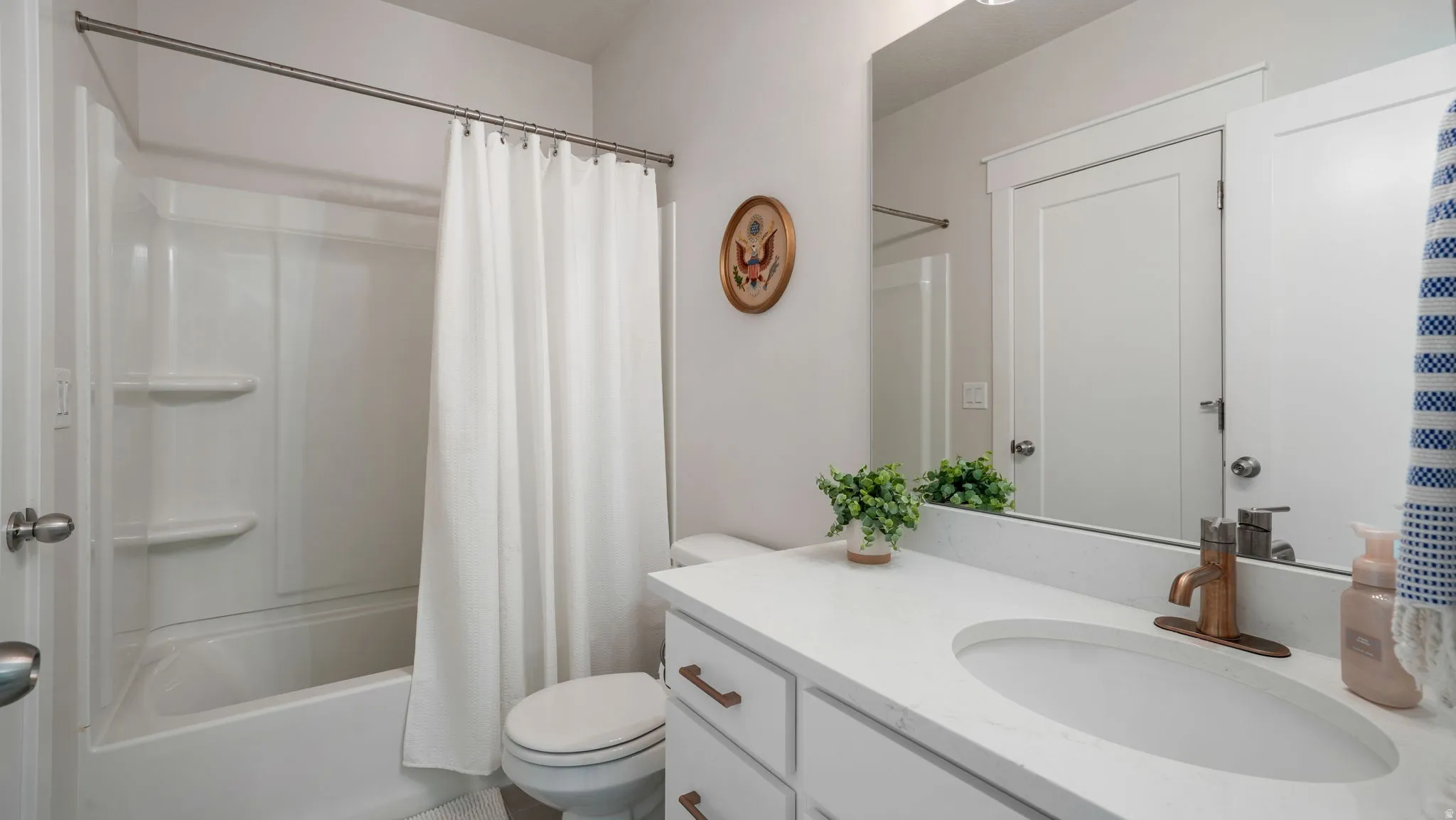 Bathroom featuring vanity and shower / bath combo