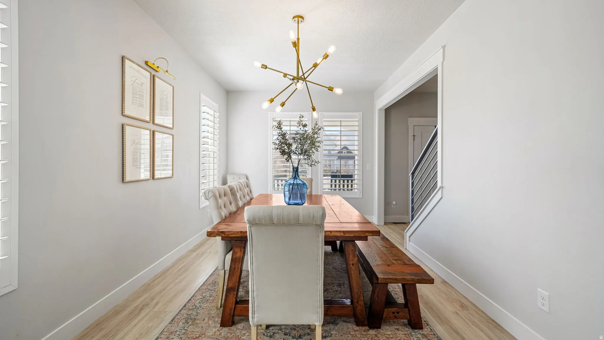 Dining space featuring hanging lights and light wood finished floors