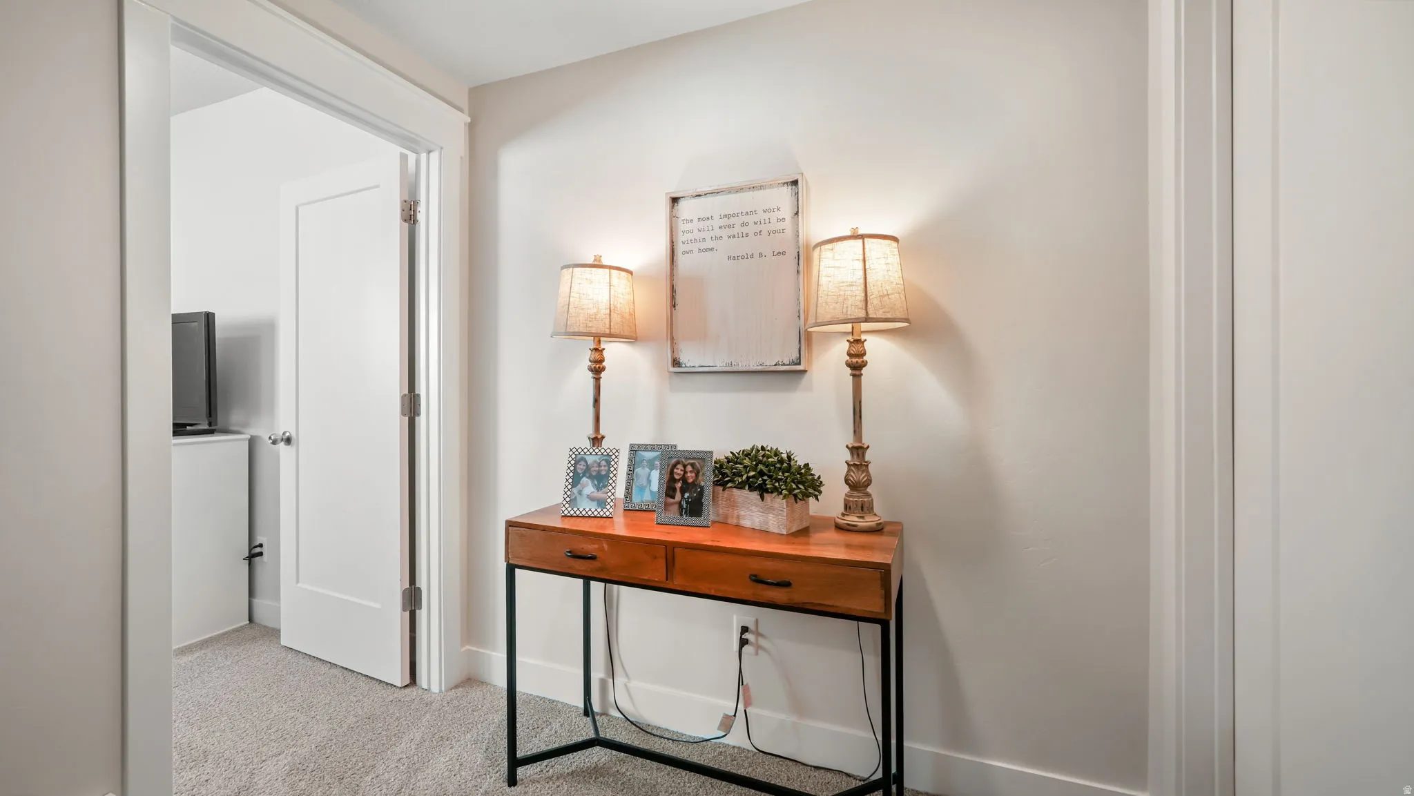 Hallway featuring light carpet and baseboards