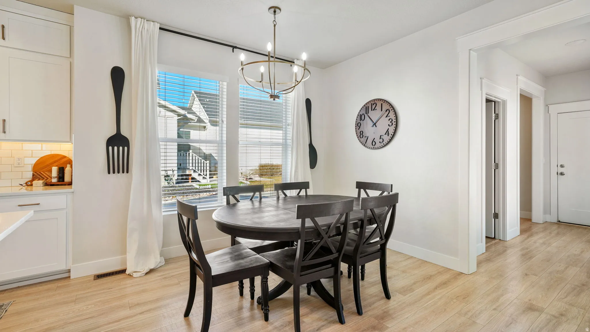 Dining space featuring light wood finished floors and hanging lights