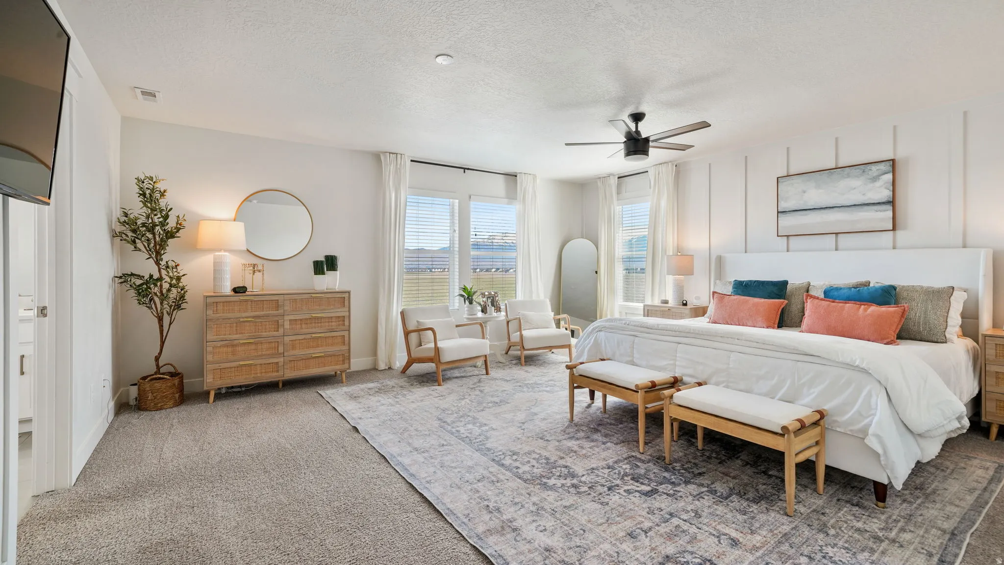 Carpeted bedroom featuring a ceiling fan and a textured ceiling