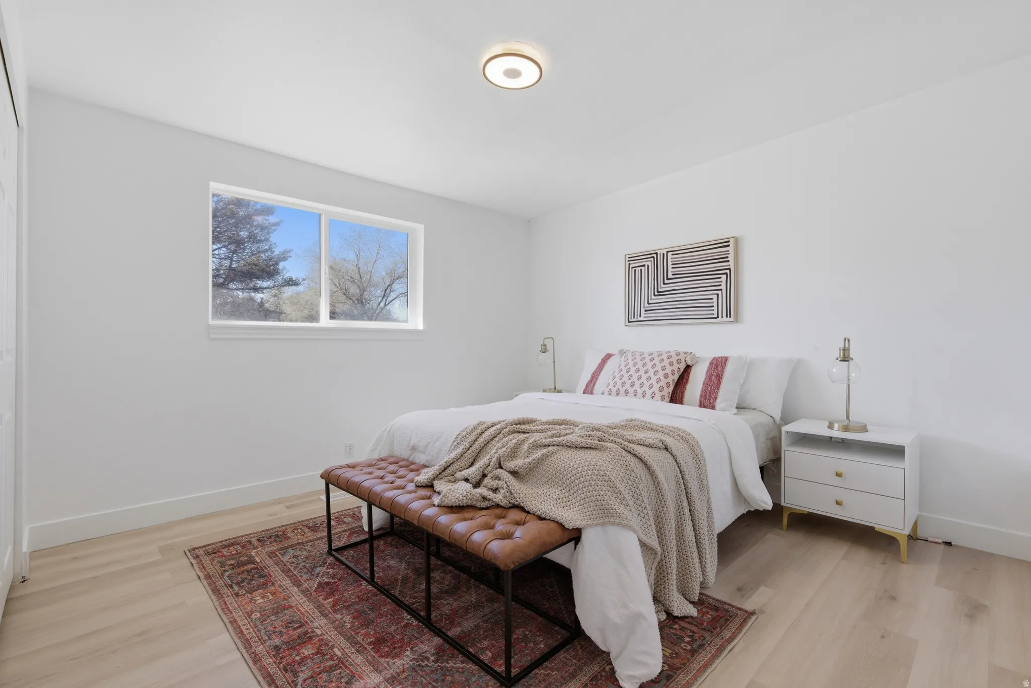 Bedroom with baseboards and light wood-type flooring