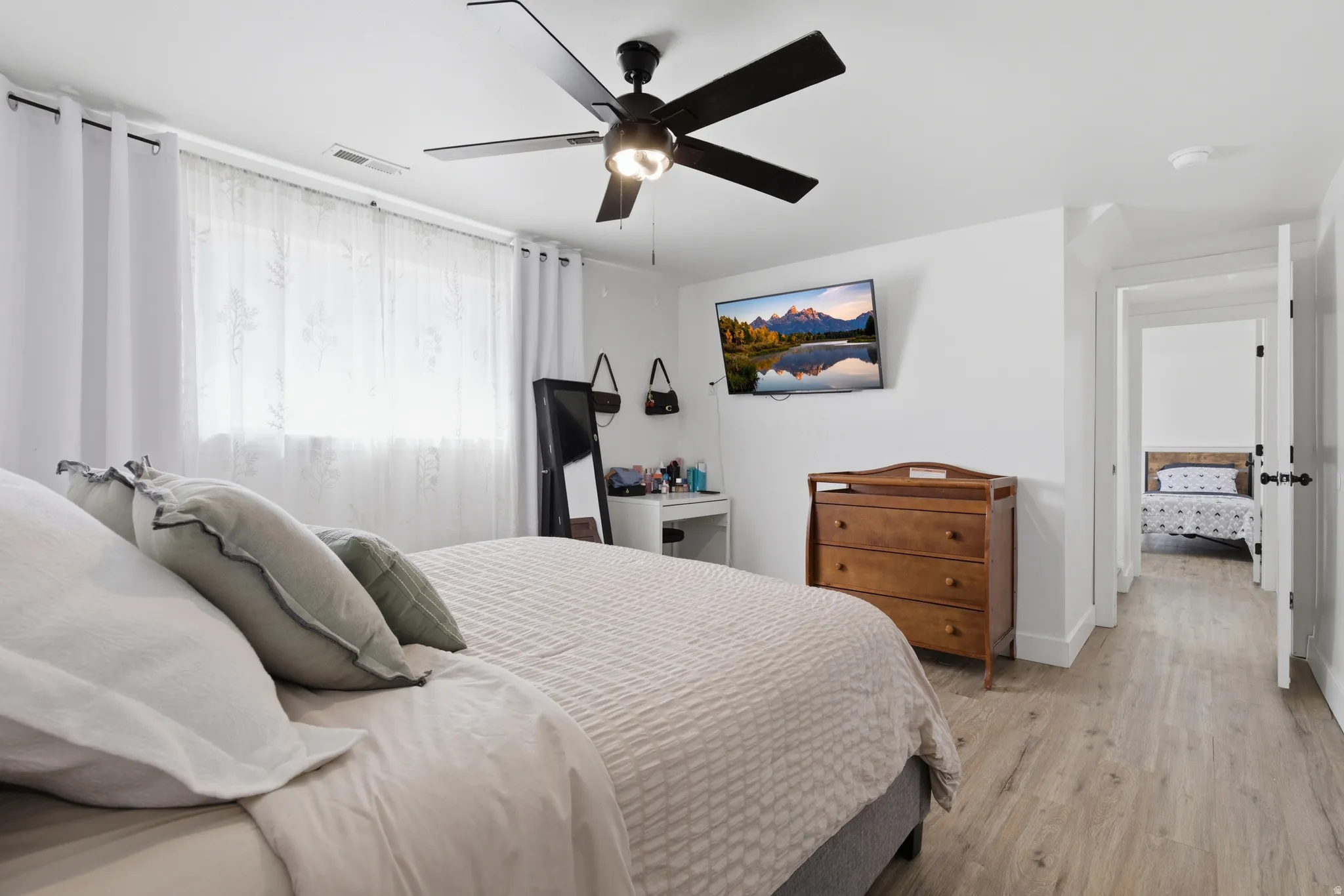 Bedroom featuring wood finished floors and a ceiling fan