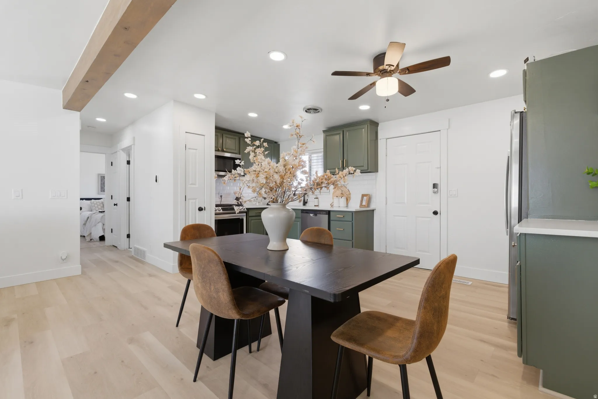 Dining space featuring light wood finished floors, a ceiling fan, and recessed lighting