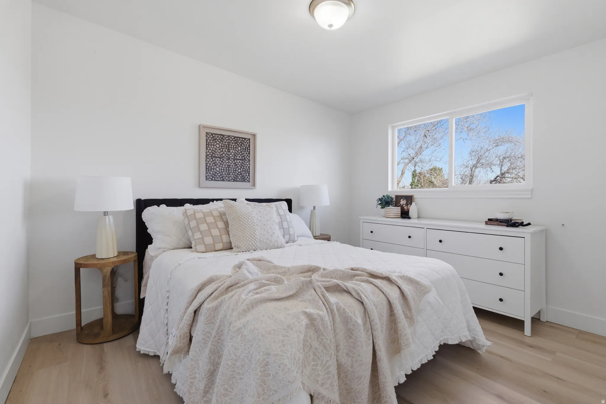 Bedroom featuring baseboards and light wood finished floors