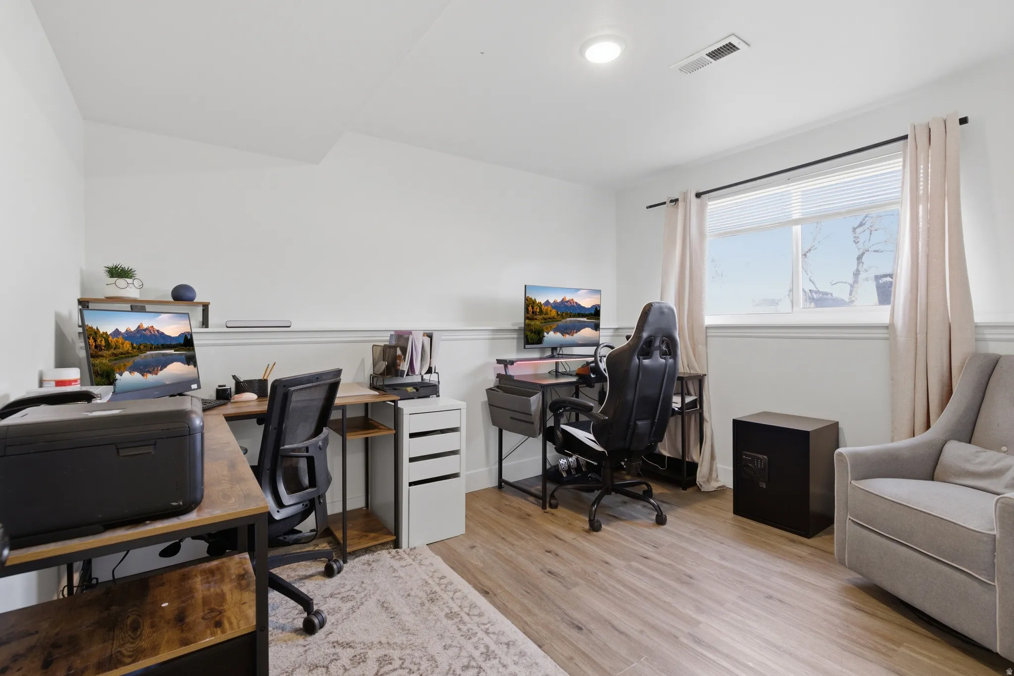 Home office featuring light wood-style floors