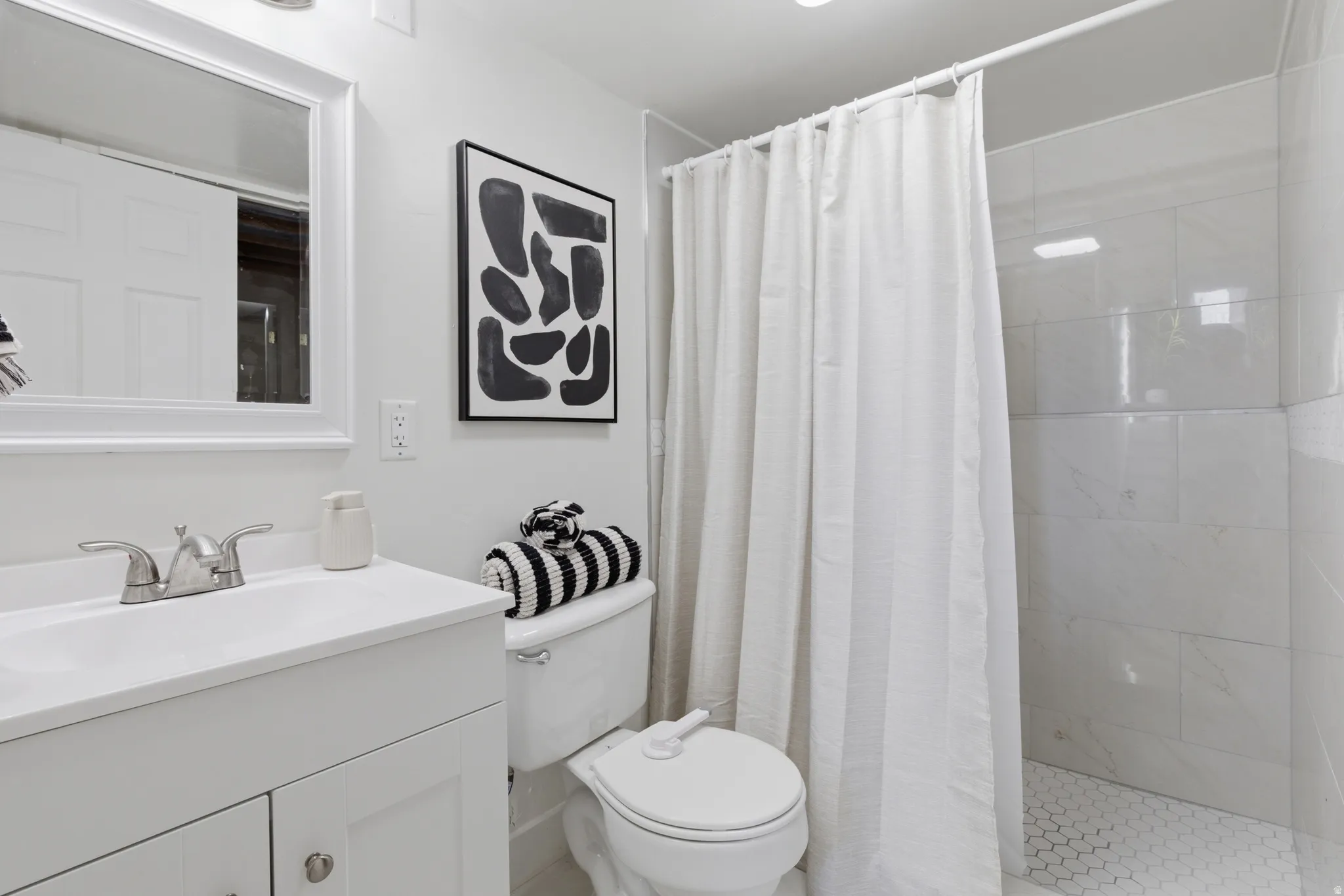 Full bathroom featuring vanity and a shower stall