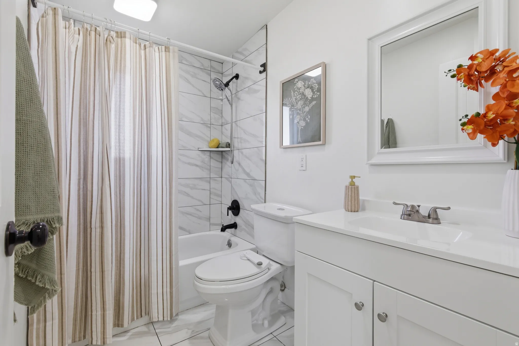 Full bathroom featuring vanity and shower / bath combo with shower curtain