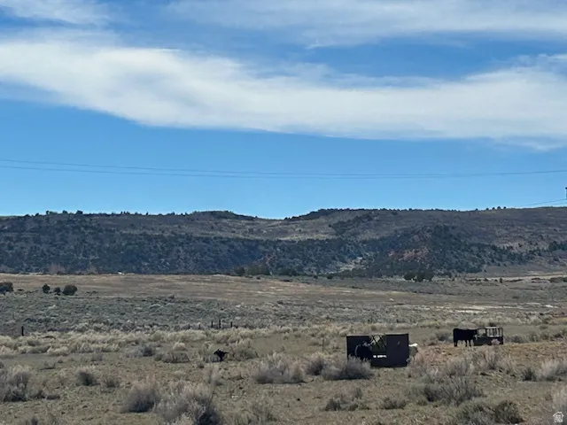 View of mountain backdrop featuring rural landscape