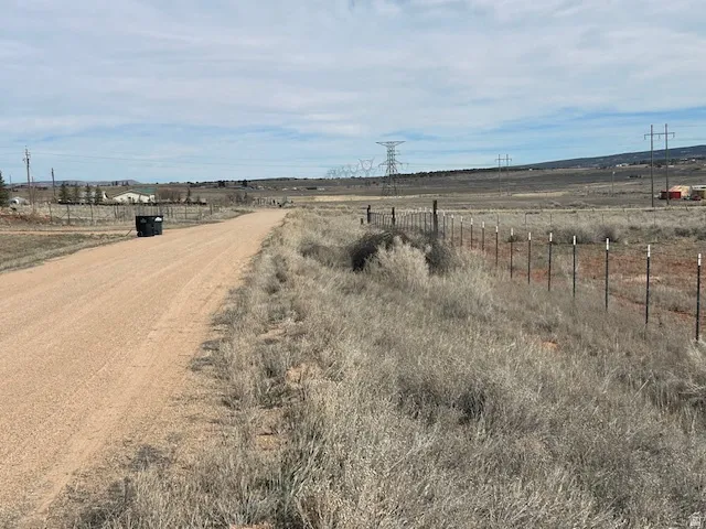 View of dirt / gravel road featuring a view of countryside