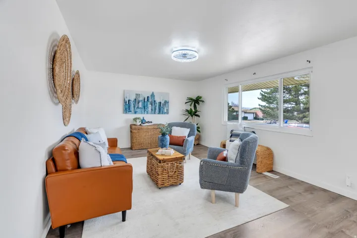 Sitting room with wood finished floors and baseboards