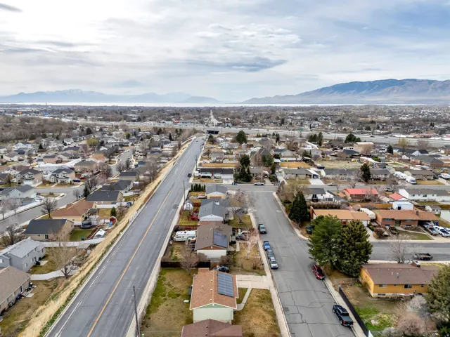 Aerial view of property's location with a mountainous background and nearby suburban area