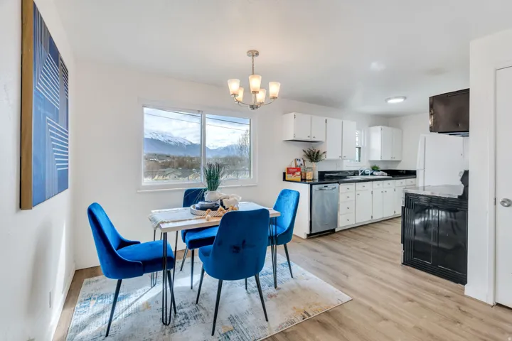Dining area with light wood-style flooring, hanging lights, healthy amount of natural light, and a mountain view