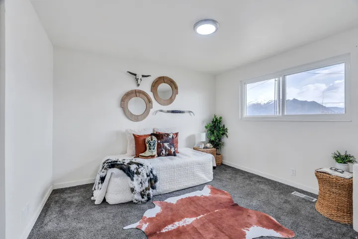 Bedroom featuring carpet flooring and baseboards