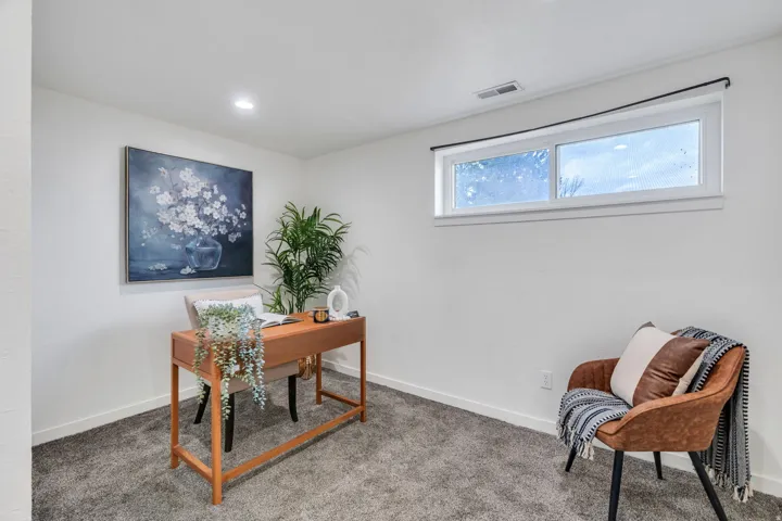 Carpeted office featuring baseboards and recessed lighting