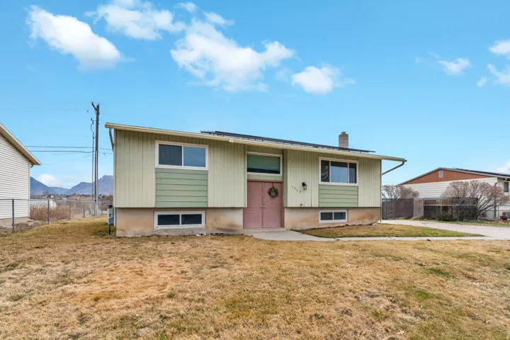Split foyer home featuring a mountain view and a chimney