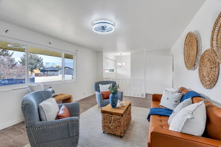 Living area with wood finished floors and suspended lighting