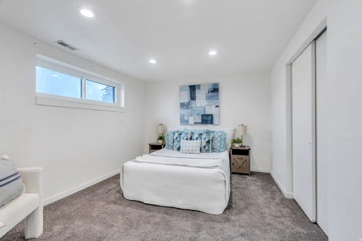 Bedroom with carpet flooring, recessed lighting, and a closet