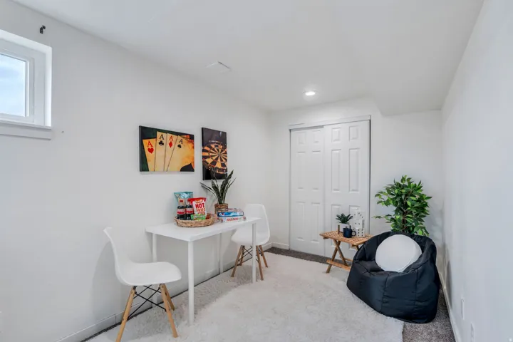 Office with light colored carpet and baseboards