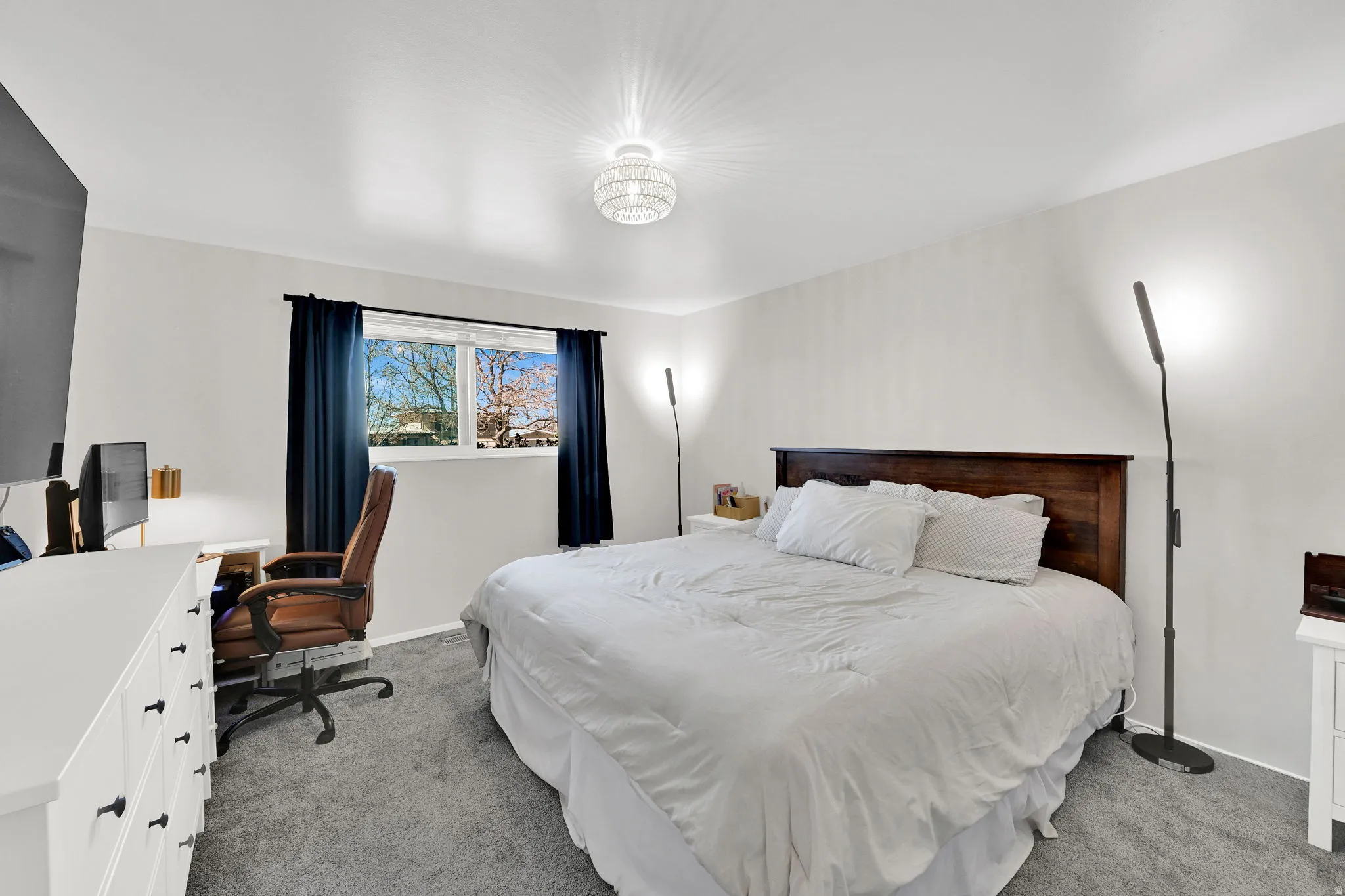 Bedroom with light colored carpet