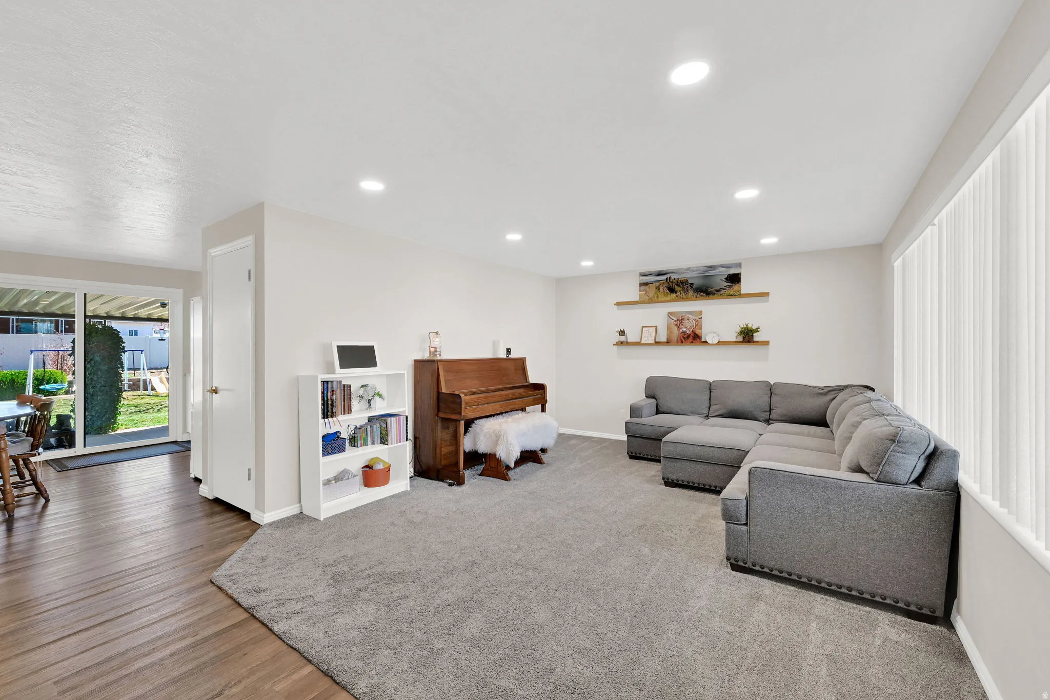 Living area featuring recessed lighting and light wood-style flooring