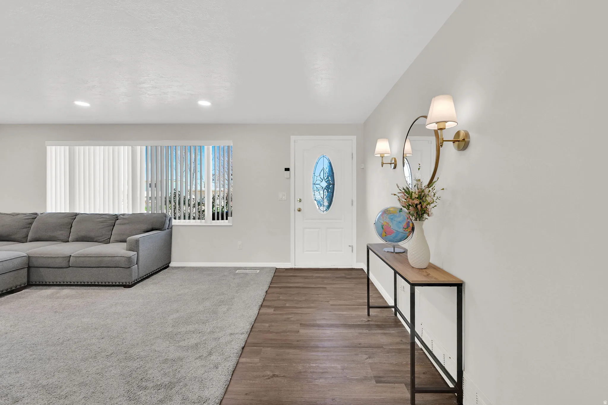 Entrance foyer with wood finished floors and recessed lighting