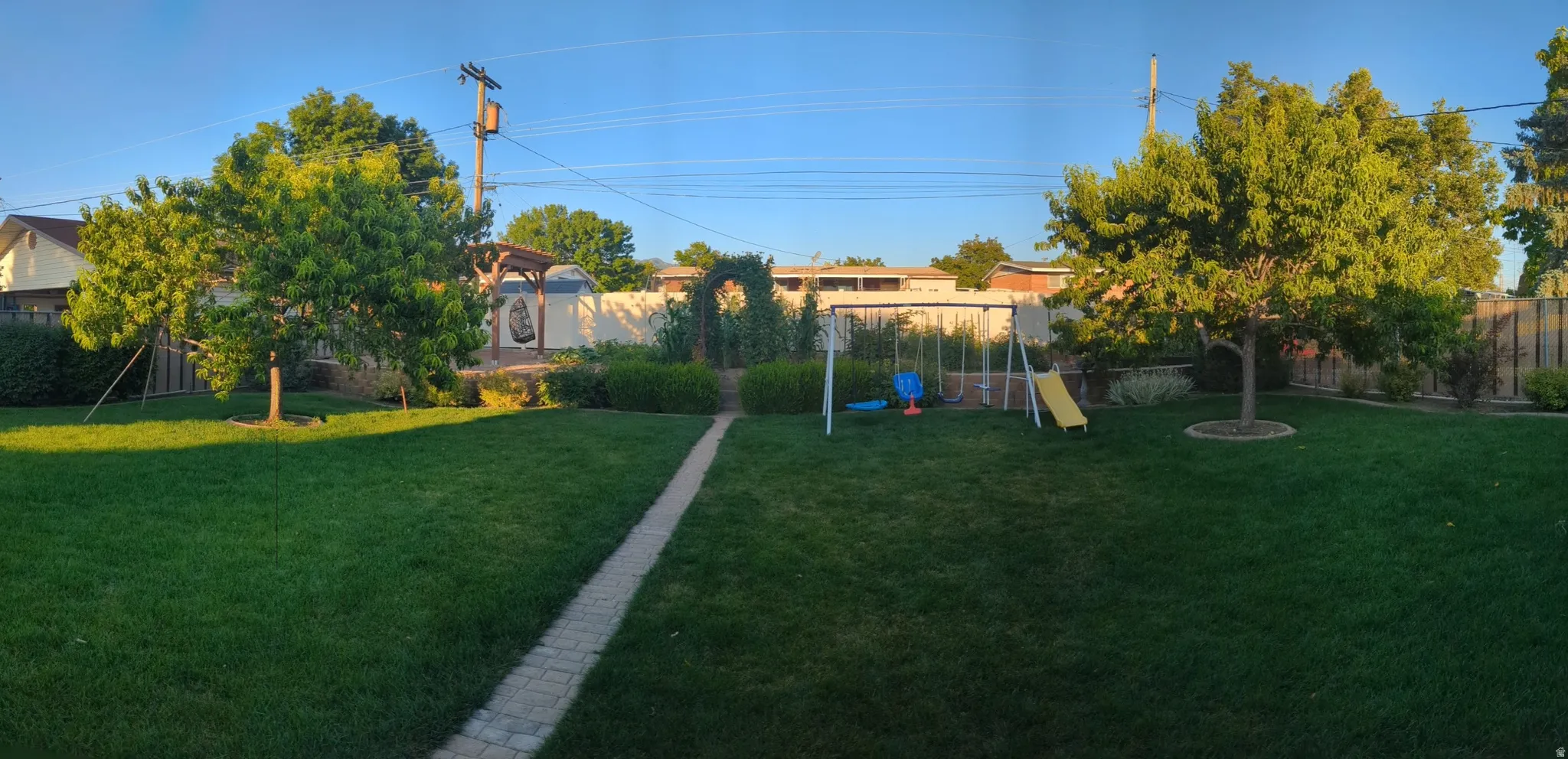 Fenced backyard with a playground