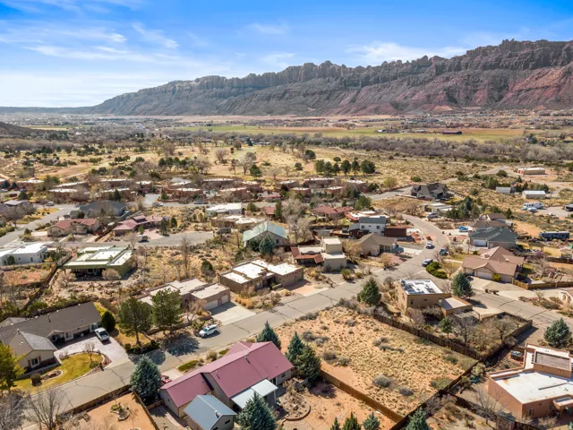Aerial perspective of suburban area featuring a mountainous background
