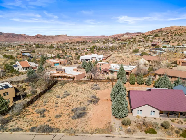 Aerial perspective of suburban area featuring a mountain backdrop