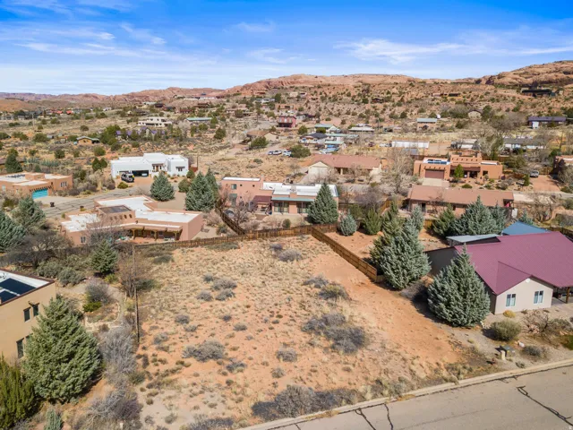 Aerial perspective of suburban area with mountains and a desert landscape