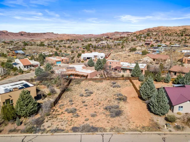 Aerial view of property's location featuring a mountain backdrop and nearby suburban area