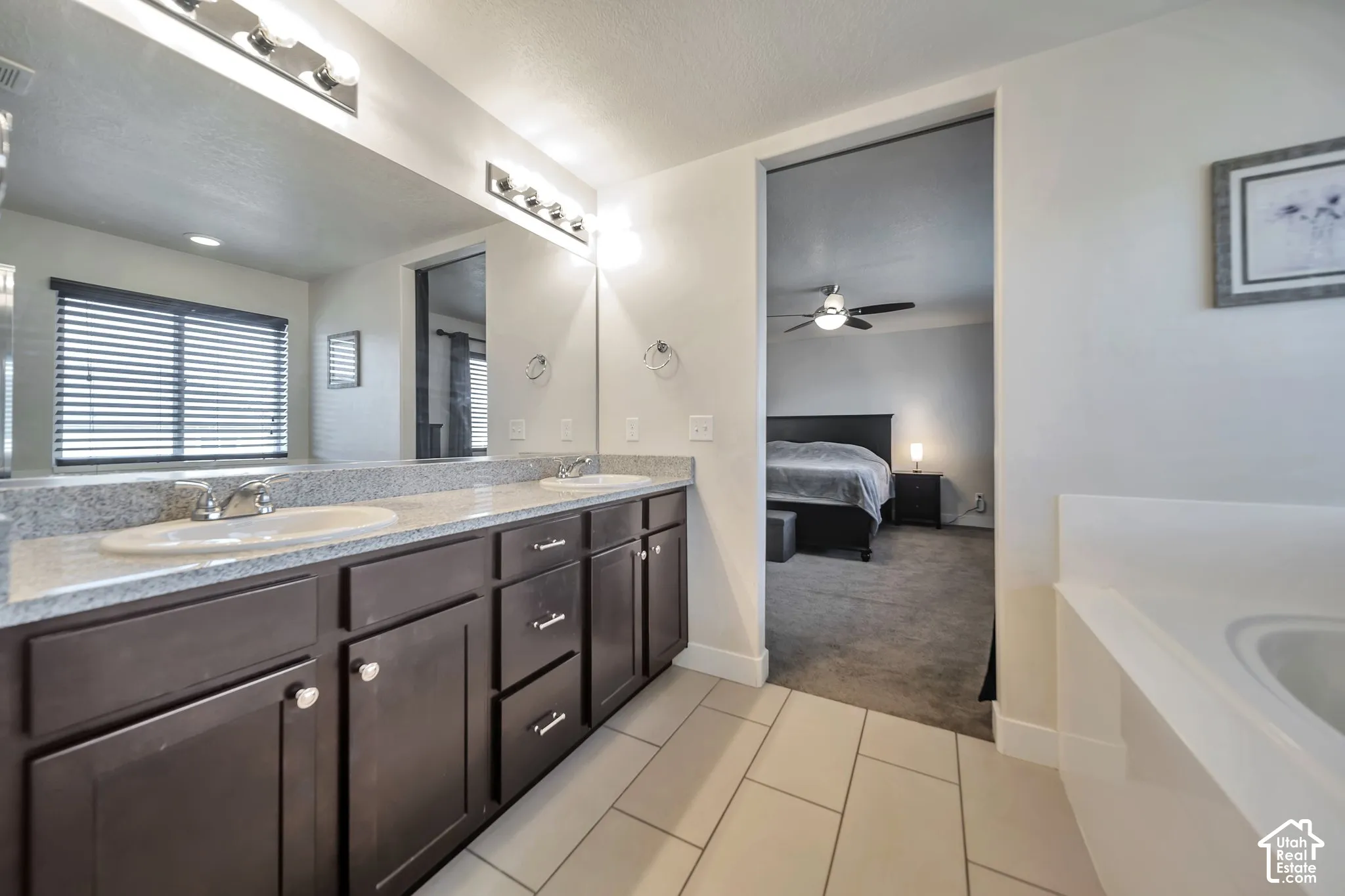 Ensuite bathroom featuring double vanity, separate tub/shower