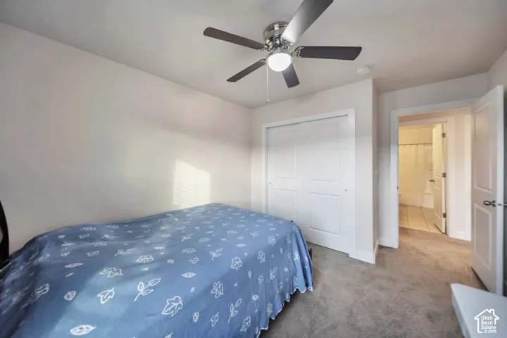 Bedroom featuring carpet floors, a closet, and a ceiling fan