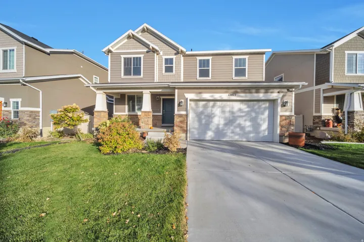 Craftsman inspired home with stone siding, covered porch, concrete driveway, a front lawn, and an attached garage