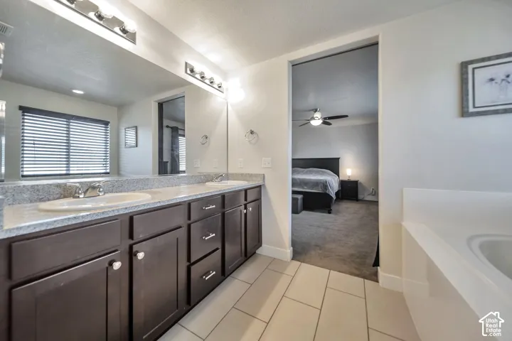 Ensuite bathroom featuring double vanity, separate tub/shower