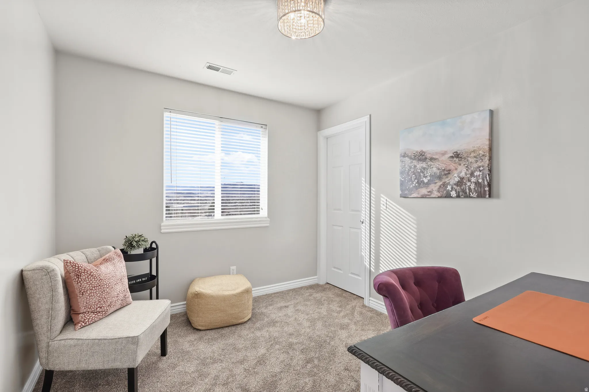 Home office featuring carpet floors and hanging lights