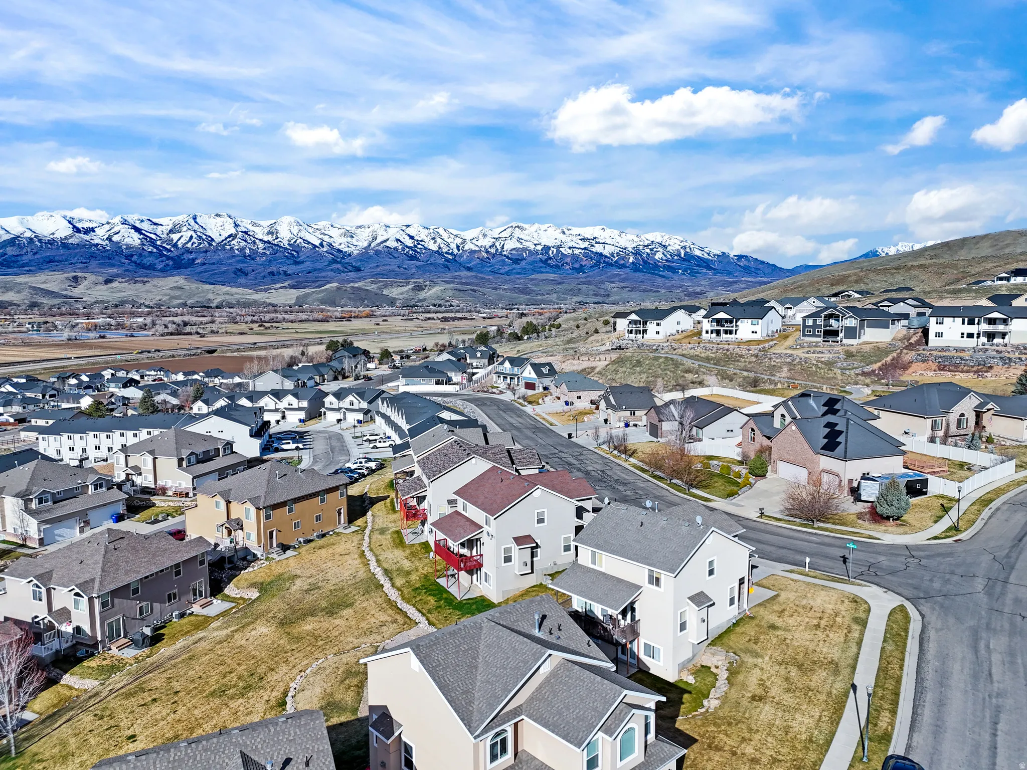 Aerial perspective of suburban area with a mountain backdrop